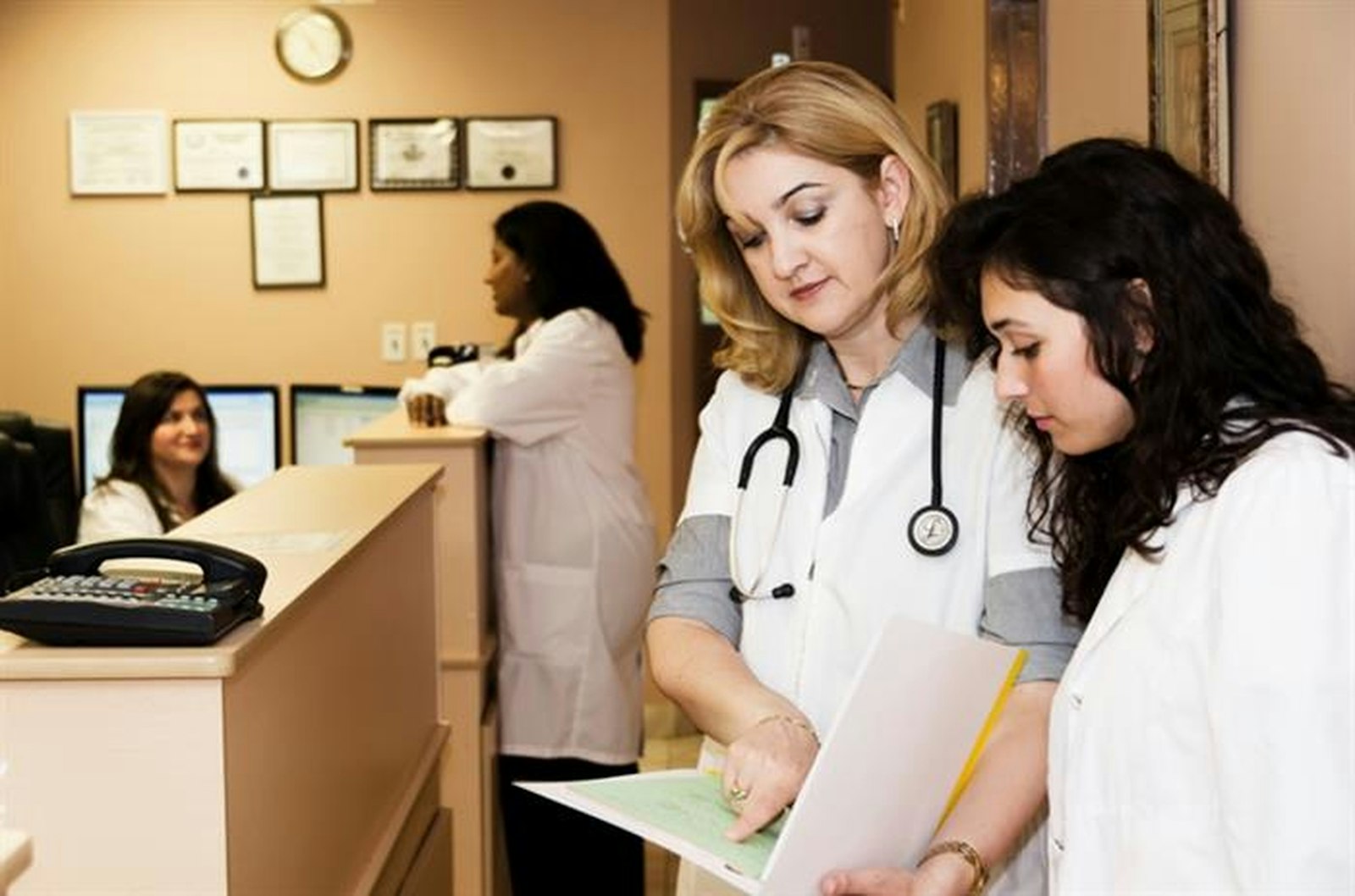 Clinic staff working together at the reception desk
